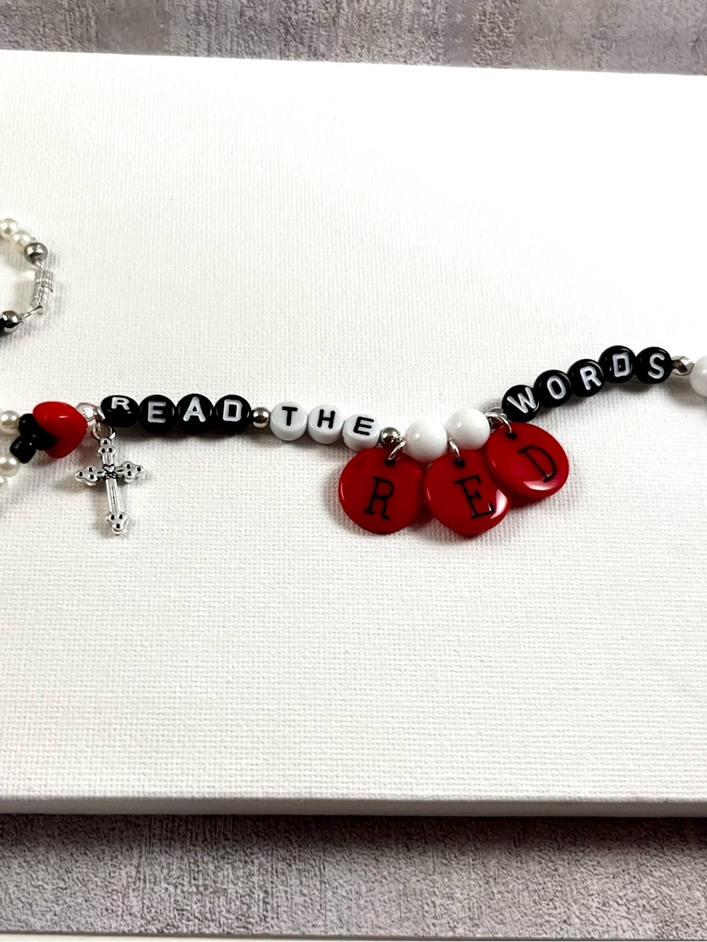 Keep the Faith close with this “read the red words” mirror charm